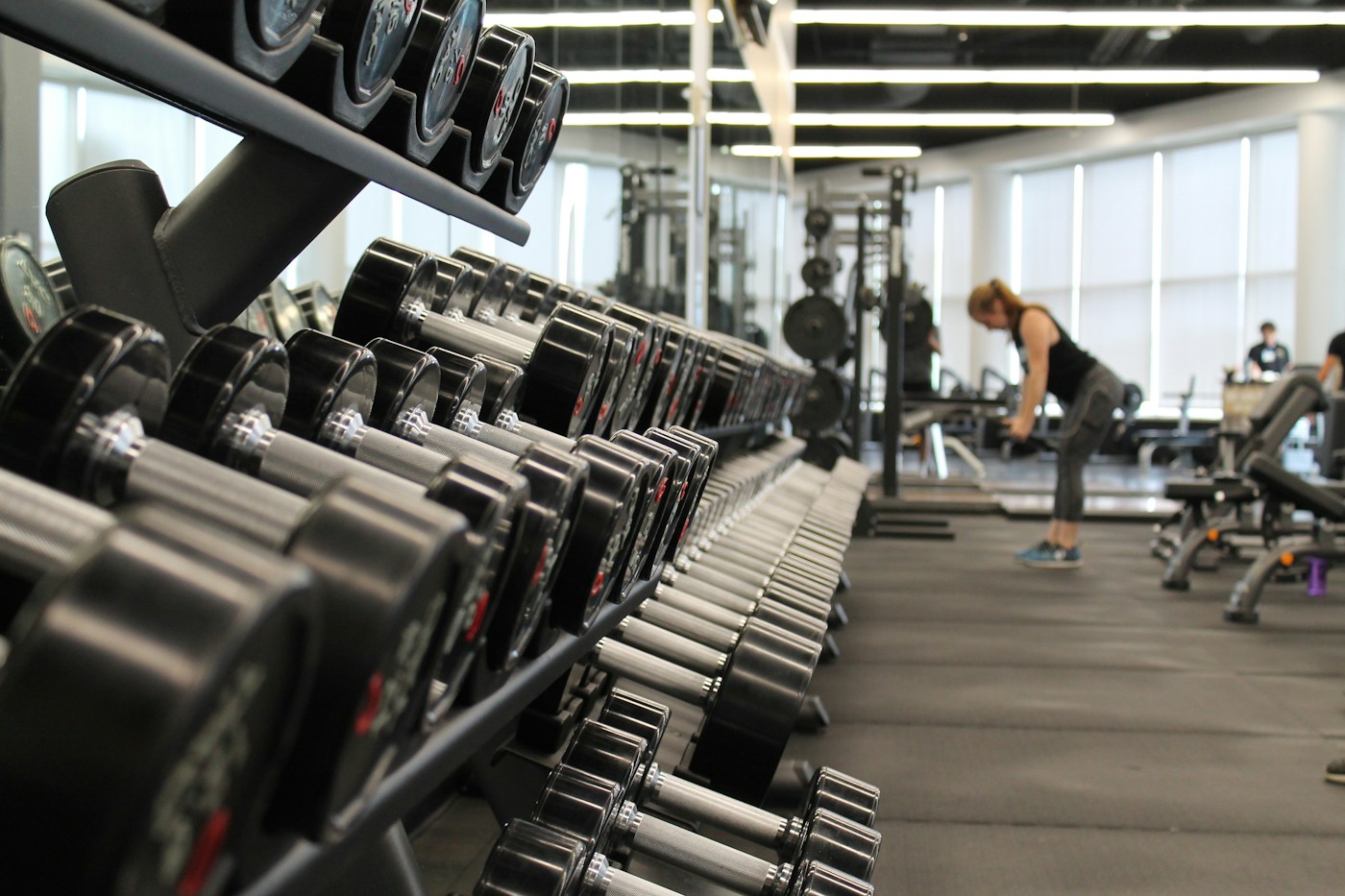 Sunlight falling across a rack of dumbbells in a training studio